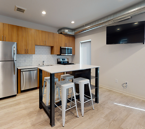 Kitchen with movable island and swivel mounted TV